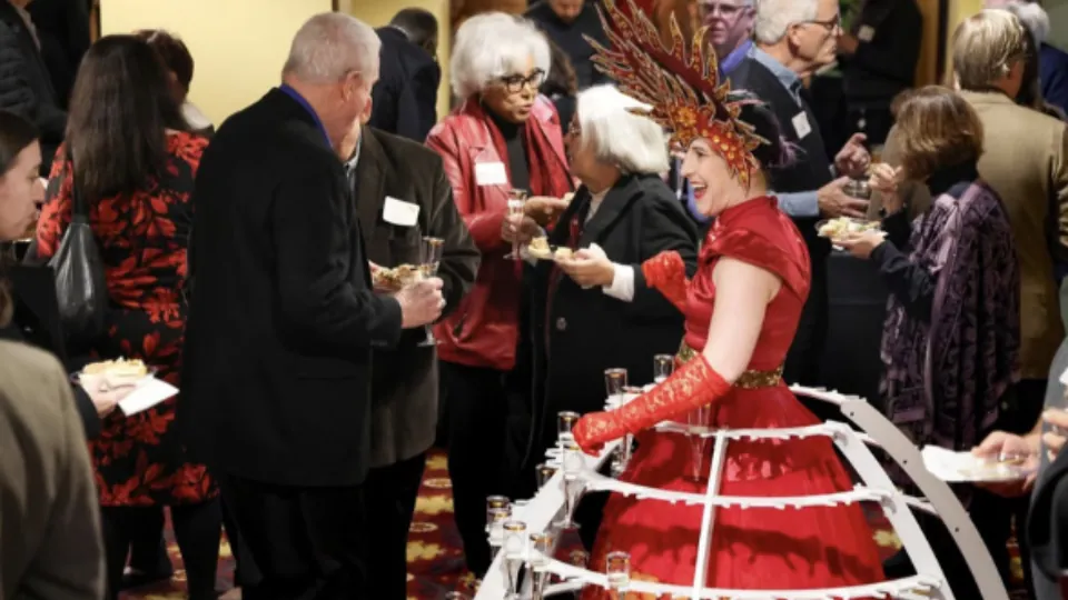 Beverage dress performer serving guests at a corporate event
