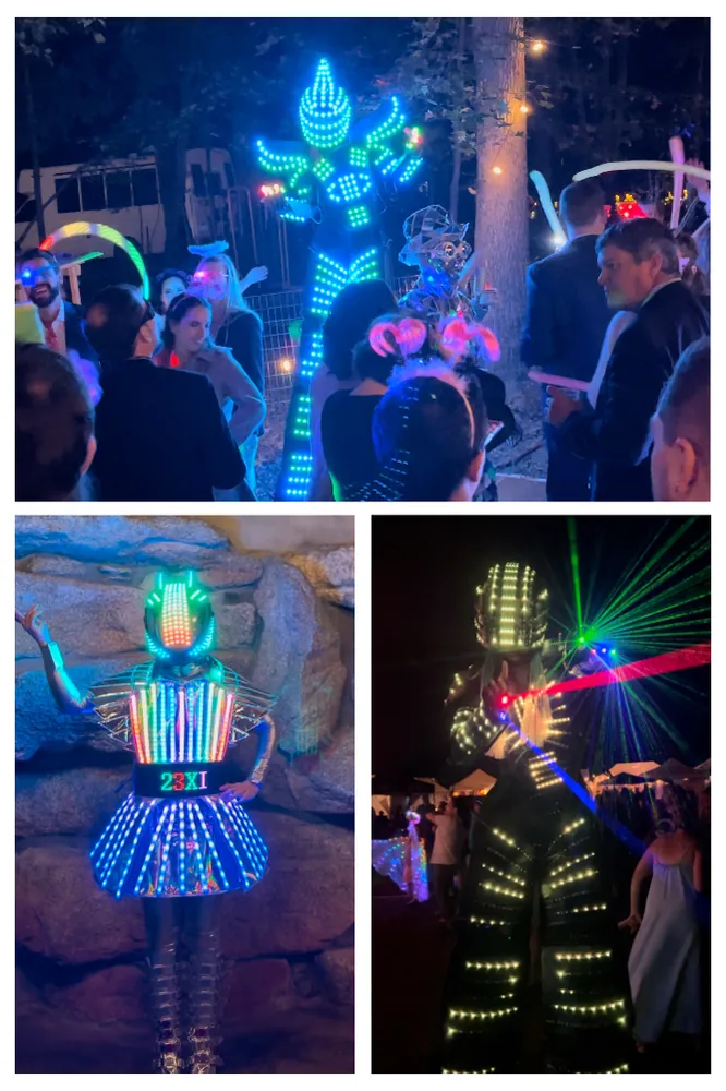 LED party robots and light up costumes with guests at a night party